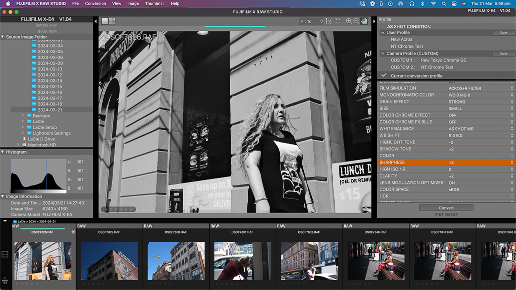 A black and white photograph of a woman walking down the street is being edited on a computer with image processing software.