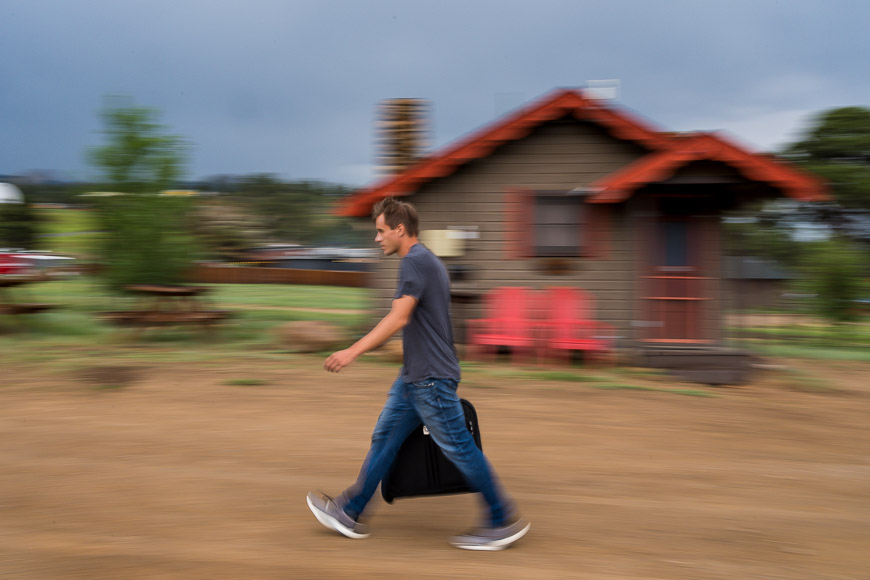 A person walking briskly with a motion blur background.