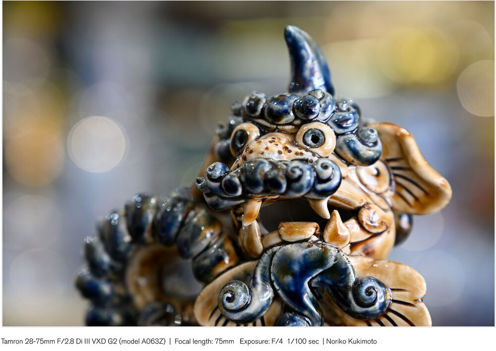 Close-up of a traditional okinawan shisa lion figurine with a blurred background.