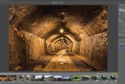 A screenshot of a photo editing software interface displaying an image of a brick-lined tunnel with arched ceiling and lights.