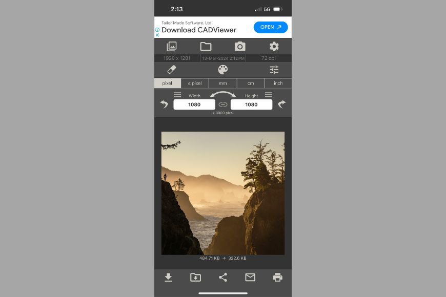 A mobile device displaying a photo of a misty coastal landscape during sunrise or sunset with user interface elements for an image editing tool.