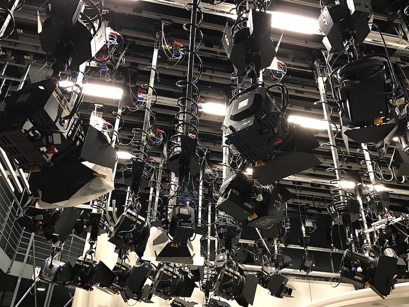 A large room with a lot of cameras hanging from the ceiling.