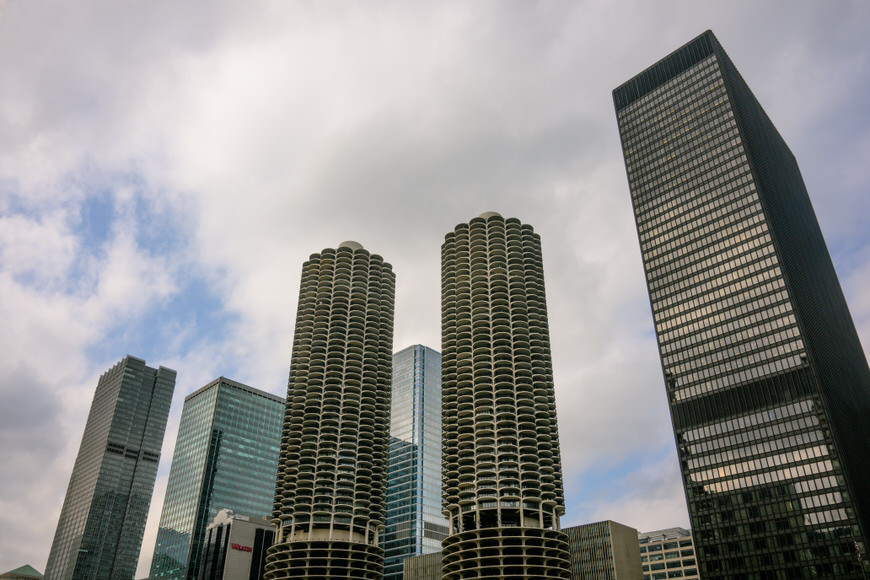 A cityscape featuring distinctive high-rise buildings under a cloudy sky.