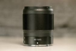 A 35mm f/1.8s lens with focus ring and markings on a neutral background.