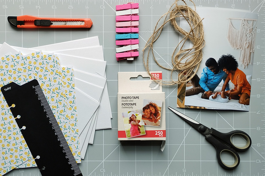 Crafting materials and a photo laid out on a cutting mat.