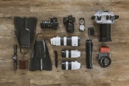 Assorted photography equipment neatly arranged on a wooden surface.