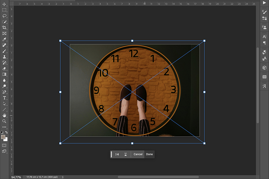 Screenshot of a graphic editing software interface showing a circular clock image being resized within a bounding box with diagonal guidelines.