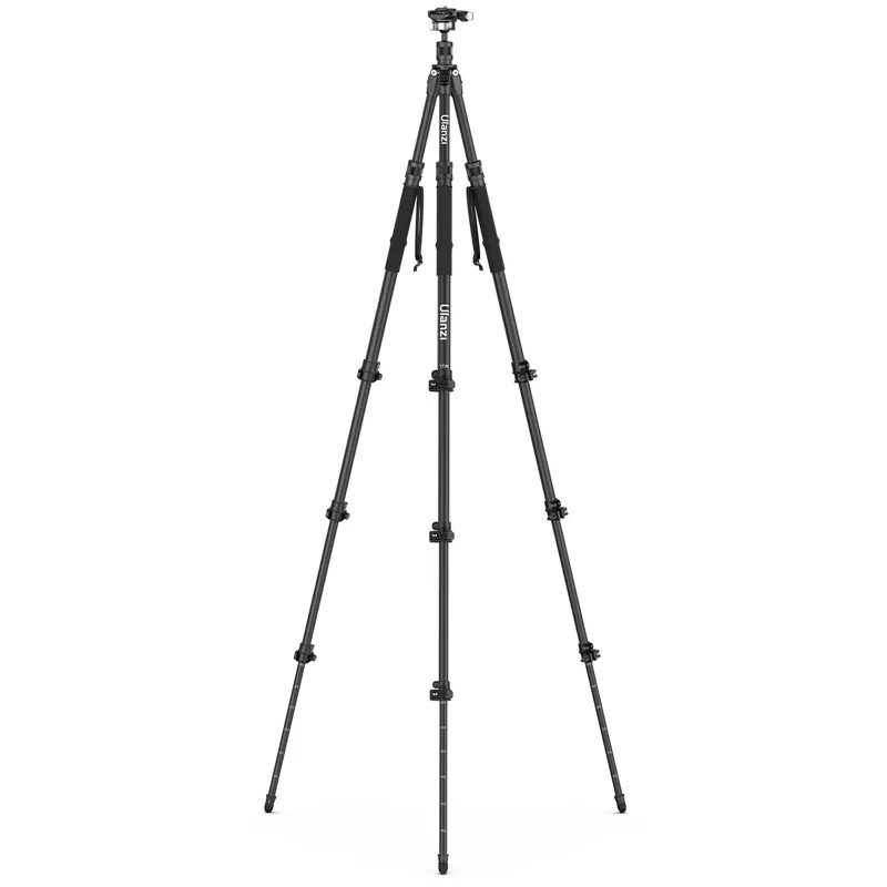 Black professional camera tripod fully extended on a white background.
