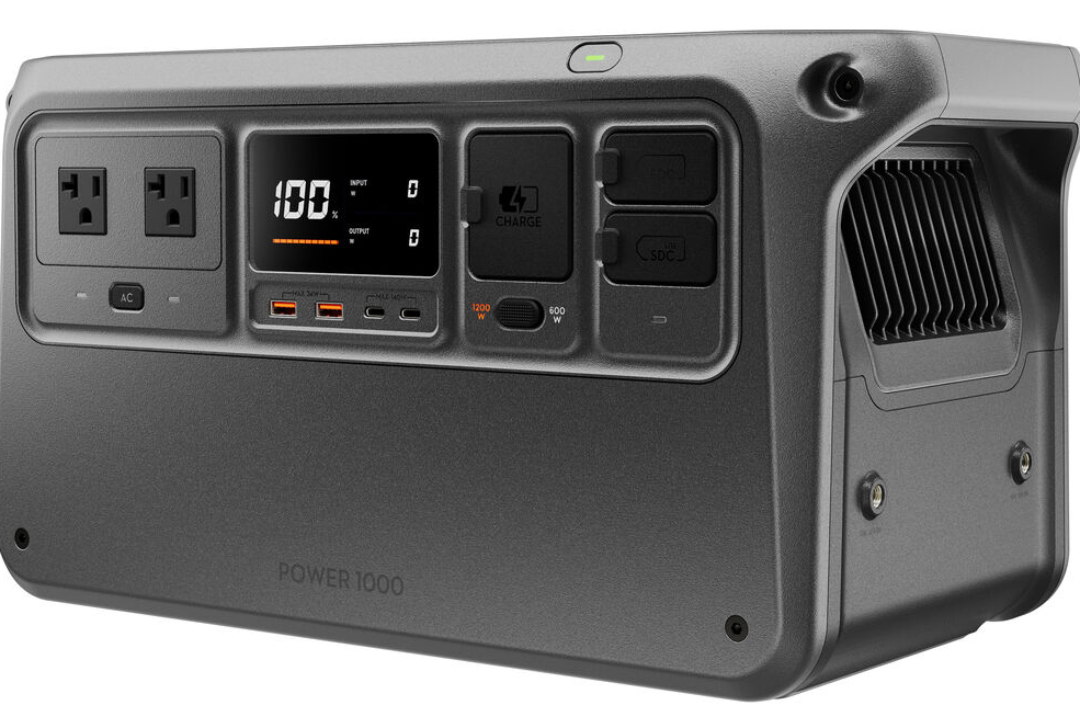 Portable power station with digital display showing charge level, multiple output ports including ac and usb, and an overall dark gray casing.