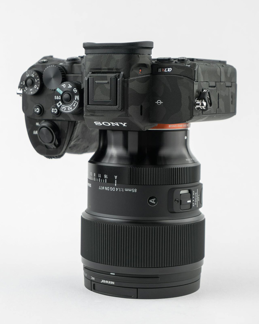 A Sony camera mounted on a Sigma lens against a white background.