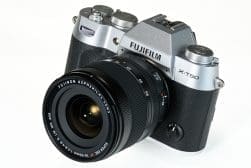 Fujifilm X-T50 mirrorless camera with a Fujinon Aspherical Lens, shown from the front on a white background.