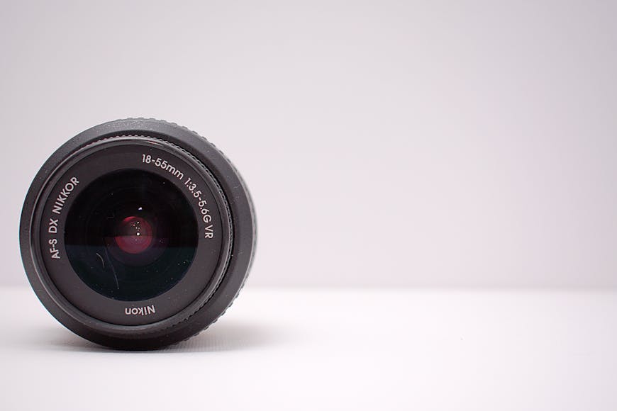 A Nikon 18-55mm lens set against a plain, light gray background.