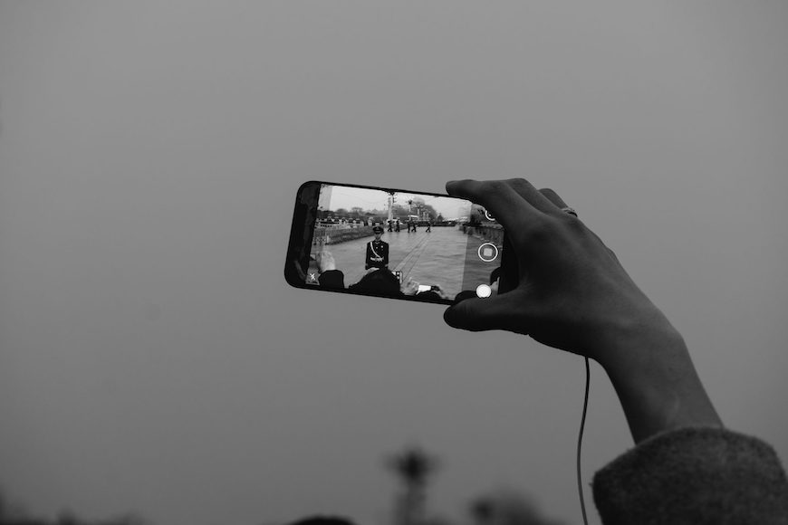 A person taking a picture with a cell phone.