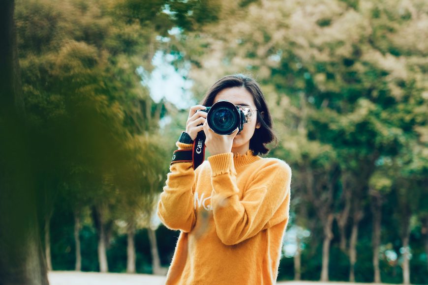 A woman taking a picture with her camera.