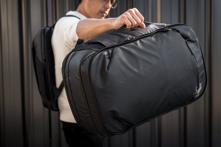 Once the shoulder straps are stowed away, the Base Pack effectively becomes a duffel that can be carried using one of its five grab handles. An optional shoulder strap would make it even more convenient to use alongside the Day Pack or any other backpack.
