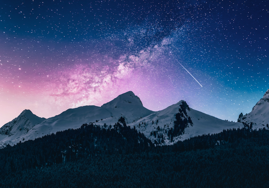 A mountain range with stars and milky in the sky.
