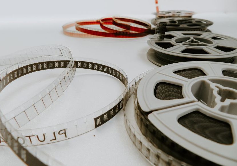 A group of film reels on a white surface.