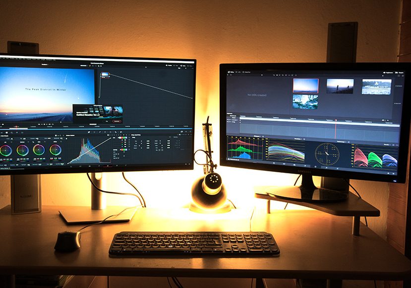 A desk with two monitors showing DaVinci Resolve.
