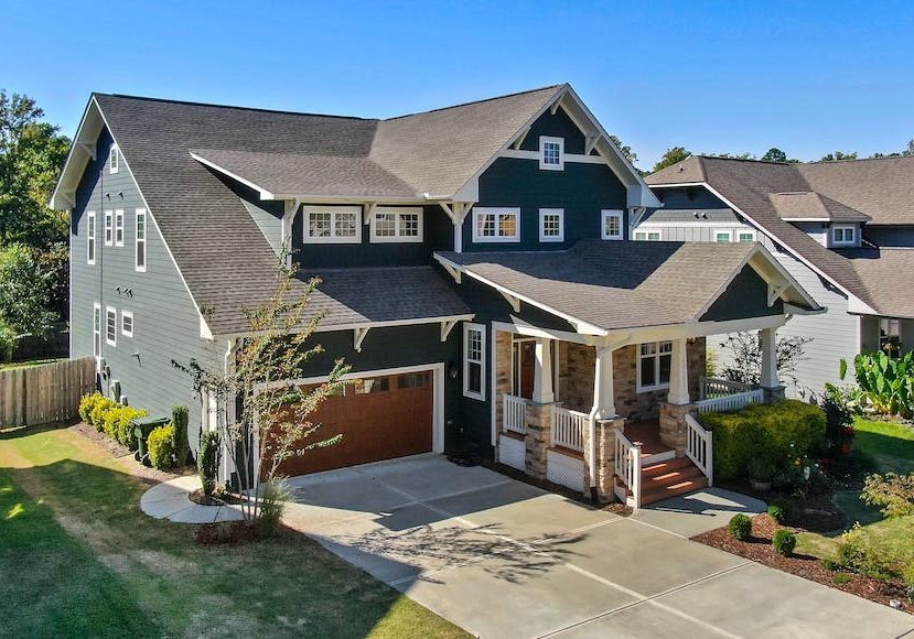An aerial view of a home with a garage and driveway.