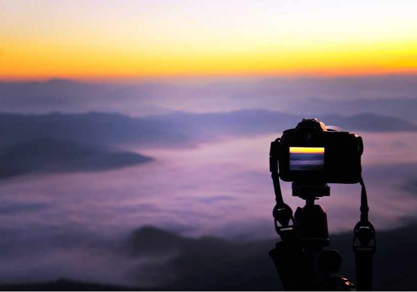 Shooting a time lapse of the sunset in top if a mountain.