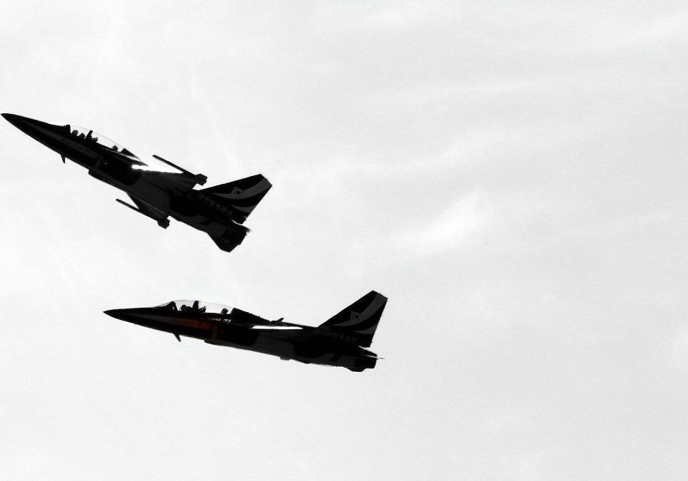 Two jets flying in the sky.