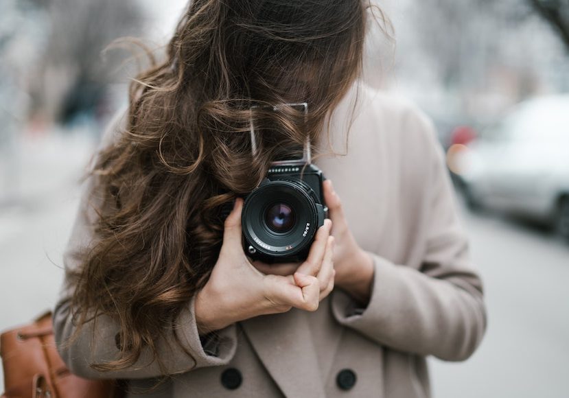 a woman is taking a picture with her camera.