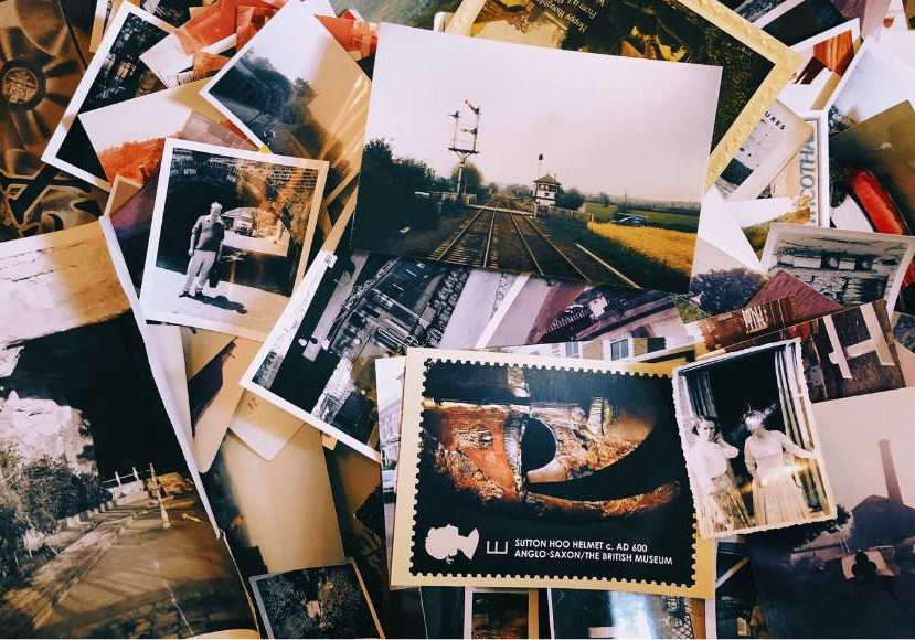 A pile of old photos on a table.