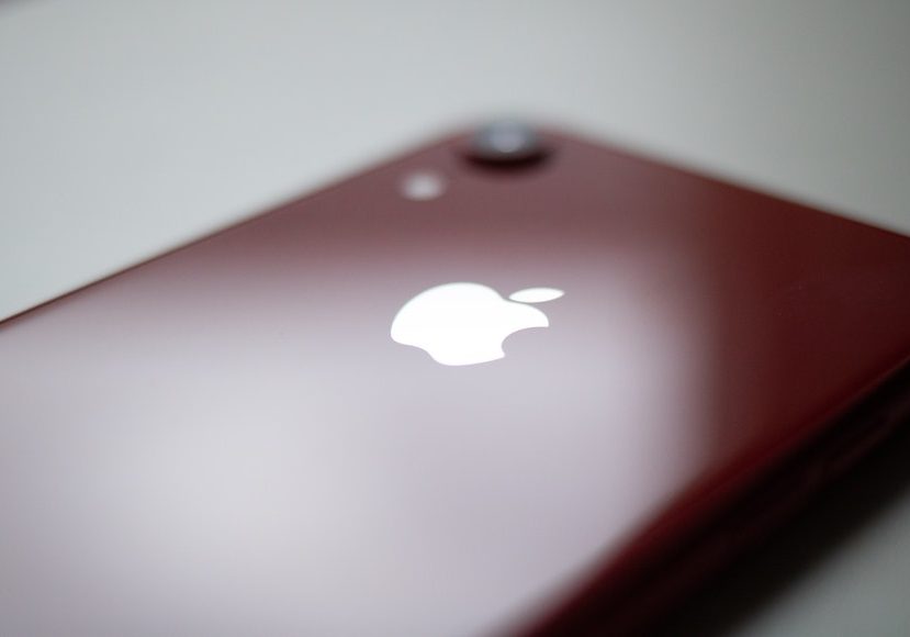 A red iphone with the apple logo on it.