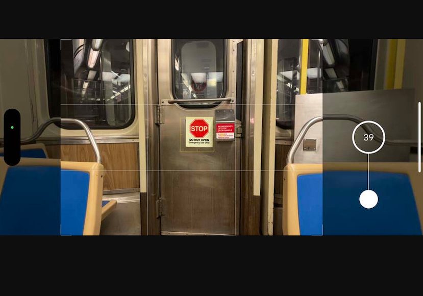 A photo of a train with a sign on the door.