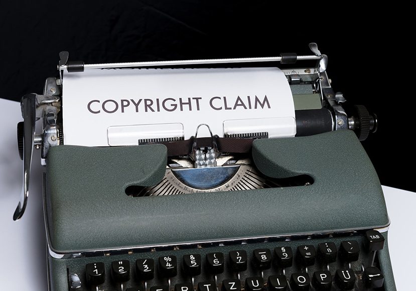A typewriter with the words copyright claim on it.