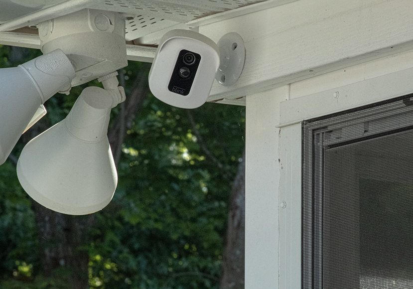A security camera mounted on the side of a house.