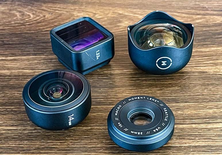 Three different types of camera lenses on a table.