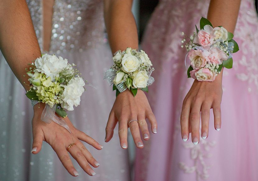 Close up to hands with corsages