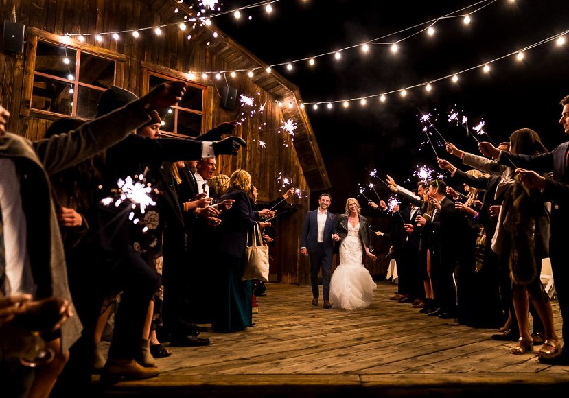 A bride and groom with sparklers at their wedding.