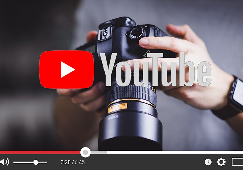 a person holding a camera with the youtube logo on it.